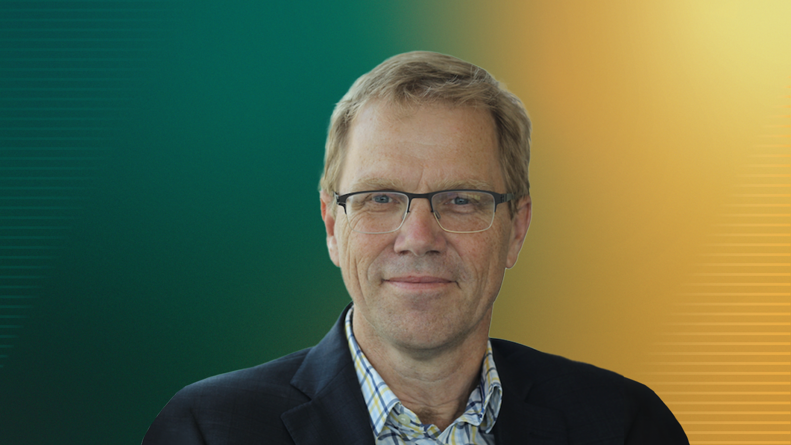 Man in a jacket and buttoned shirt wearing glasses.