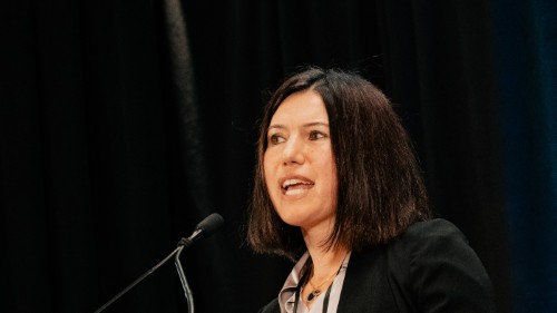 Kerry Kuluski speaking at a microphone.