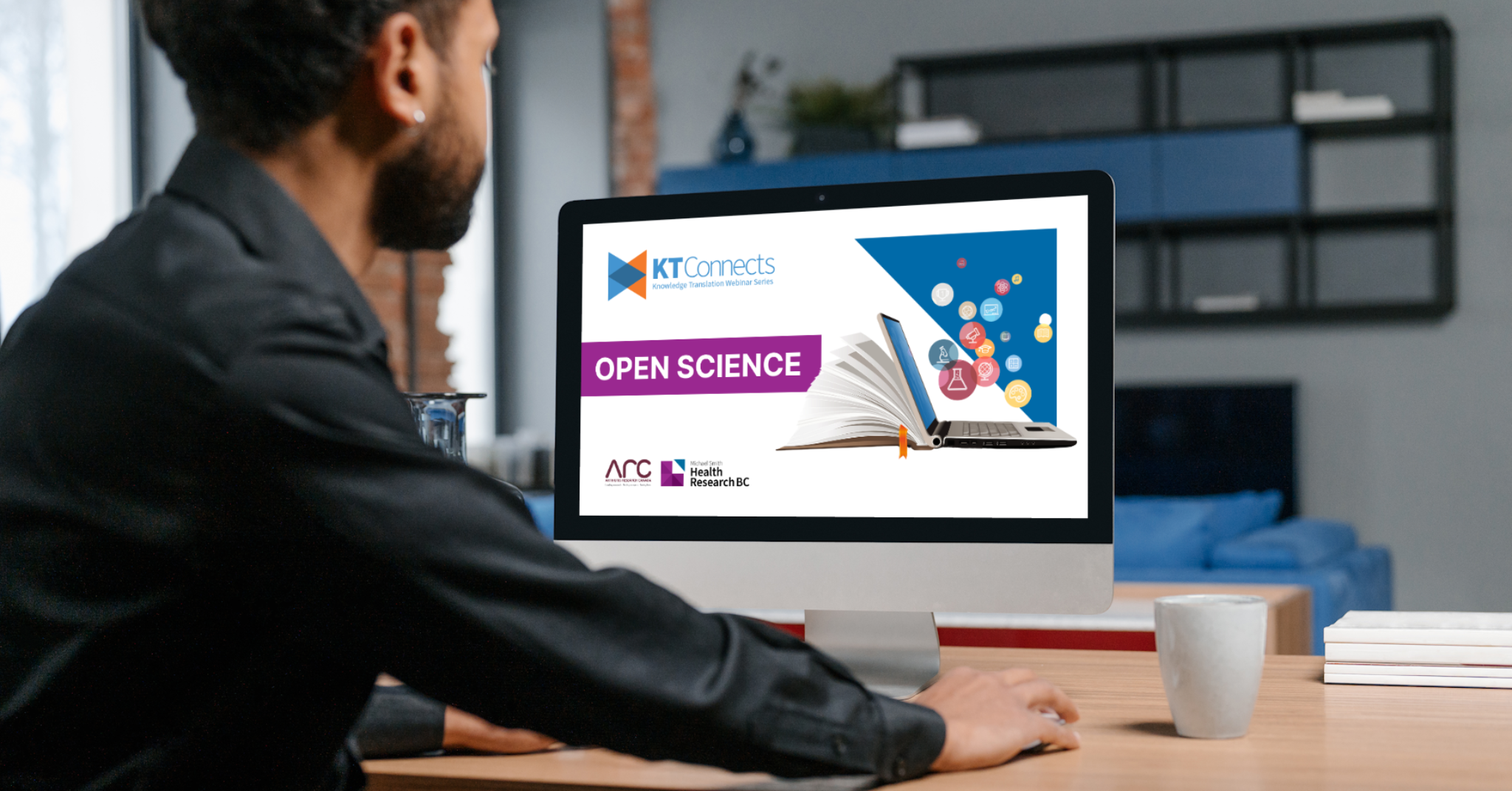 The image shows a person sitting at a desk and looking at a computer screen displaying a promotional graphic for a webinar titled "KT Connects: Open Science." The graphic features an open book with digital icons emerging from it, symbolizing knowledge sharing. The logos for Michael Smith Health Research BC and Arthritis Research Canada are visible at the bottom.