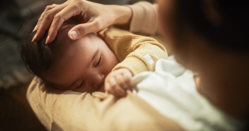 High Angle Portrait of a Cute Asian Baby Feeding from the Breast of Her Mother. Intimate Moment Between New Mother and Infant Showing Motherly Love, Tenderness, and Unconditional Affection.