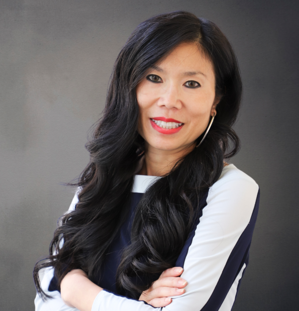 Profile photo of Tricia Tang smiling against a grey background.