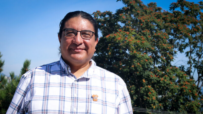 Harley Eagle smiling outside with trees in the background